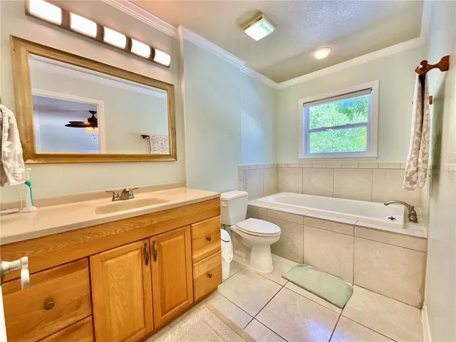 a spacious bedroom with a bed and a chandelier