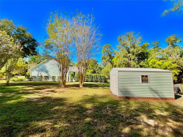 a view of a patio with lawn chairs under an umbrella