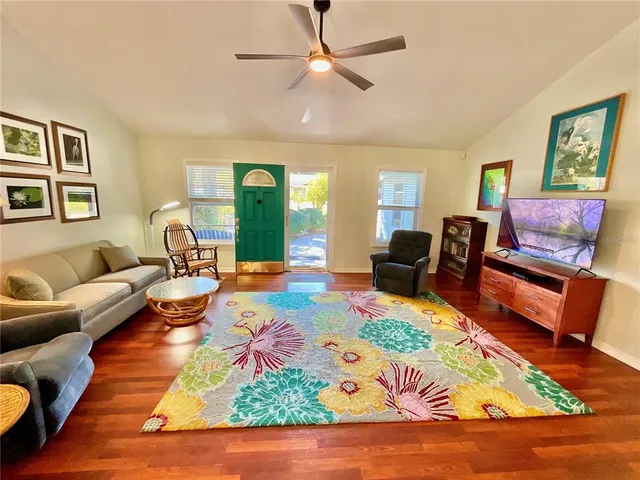 a living room with furniture and a wooden floor