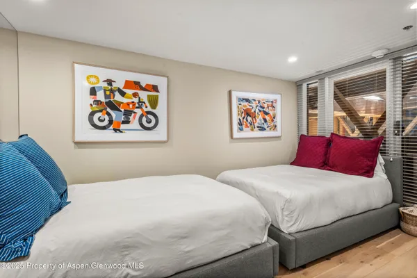 a bedroom with bed and wall painting on the wall