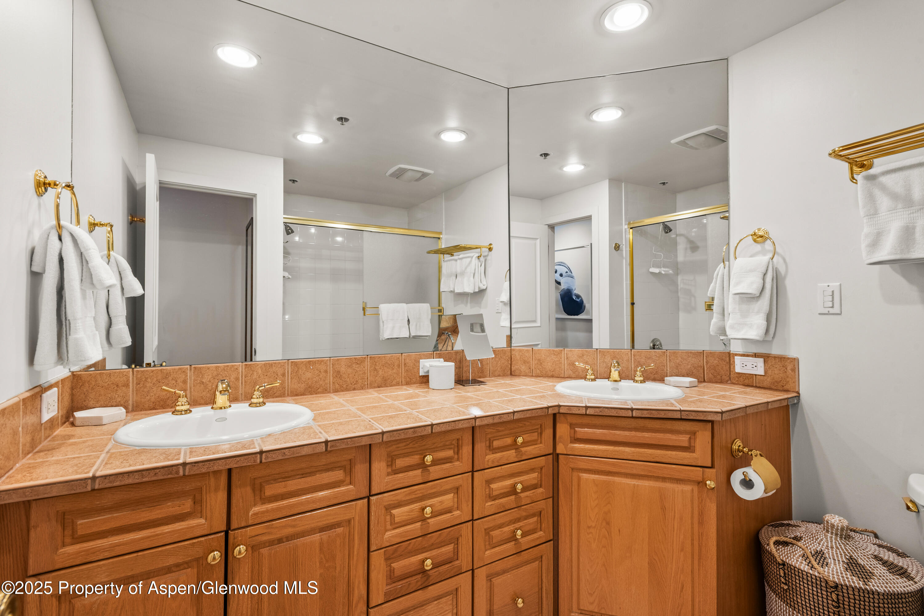 900 East Durant Avenue, Unit B105 Aspen, CO 81611 - Photo 7 of 18 a bathroom with a granite countertop sink and a mirror