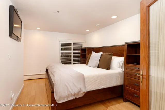 a bedroom with a bed and a night stand