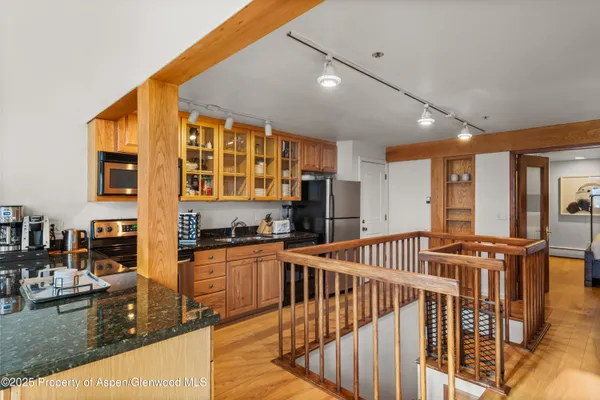 a kitchen with stainless steel appliances granite countertop a sink and cabinets