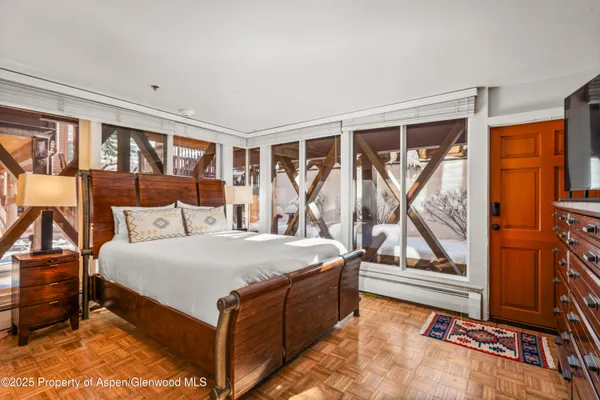 a bed sitting in a bedroom next to a window