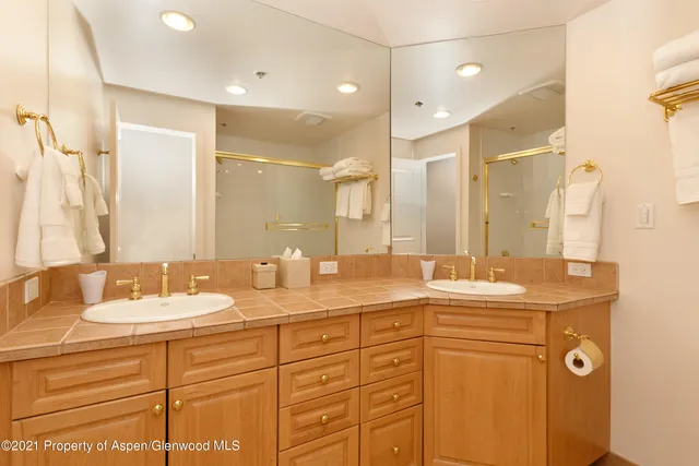 a bathroom with a granite countertop sink mirror and double