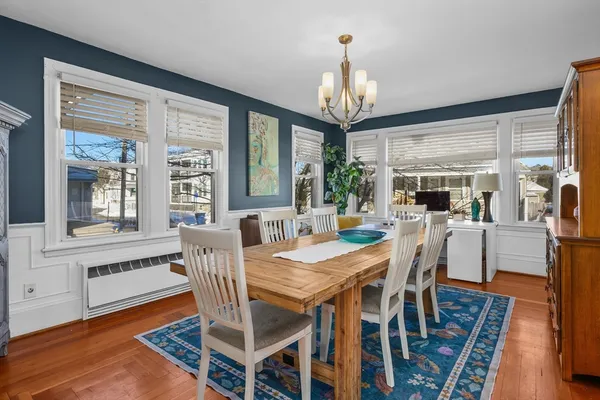 a view of a dining room with furniture window and wooden floor