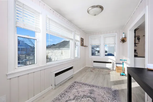 a living room with stainless steel appliances kitchen island granite countertop furniture and a large window