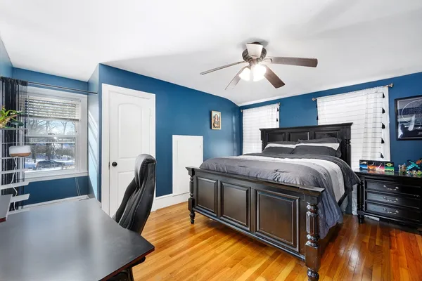 a bedroom with a bed closet and a window