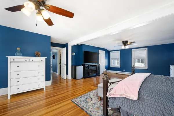 a spacious bedroom with a bed and a chandelier