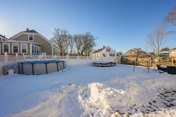 a view of a house with a yard covered in snow