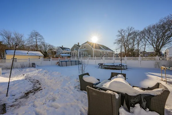 a view of a patio with dining table and chairs with wooden floor