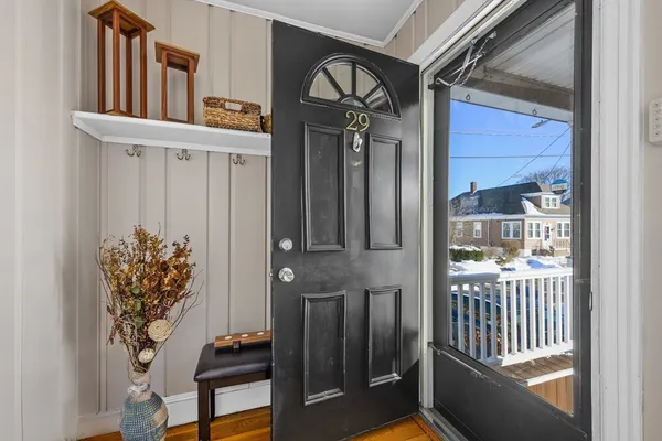 a view of a hallway with entryway and front door