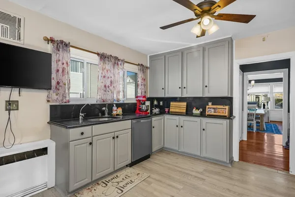 a kitchen with a sink cabinets and window