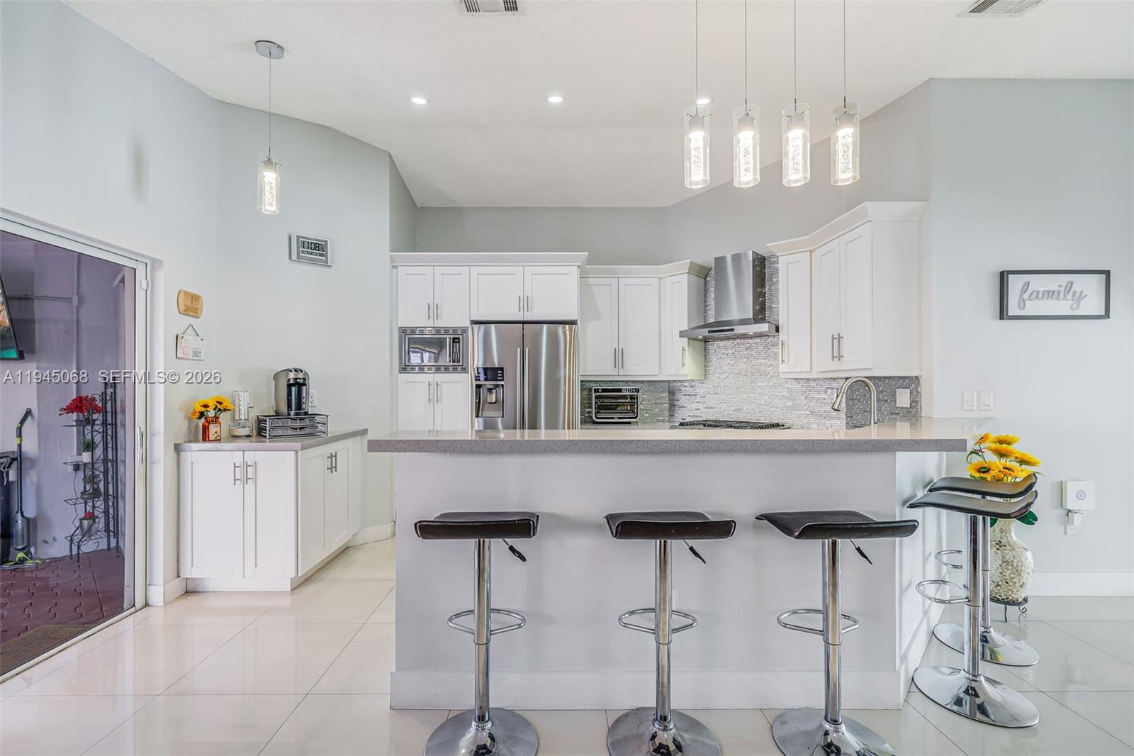 9526 Southwest 155th Avenue Miami, FL 33196 - Photo 17 of 53 a kitchen with stainless steel appliances granite countertop a counter top space cabinets and a sink