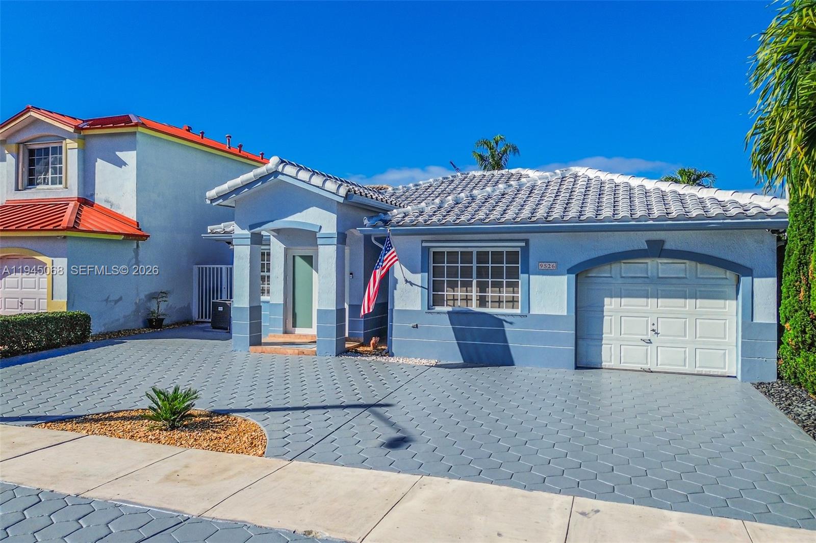 9526 Southwest 155th Avenue Miami, FL 33196 - Photo 2 of 53 a front view of a house with garden