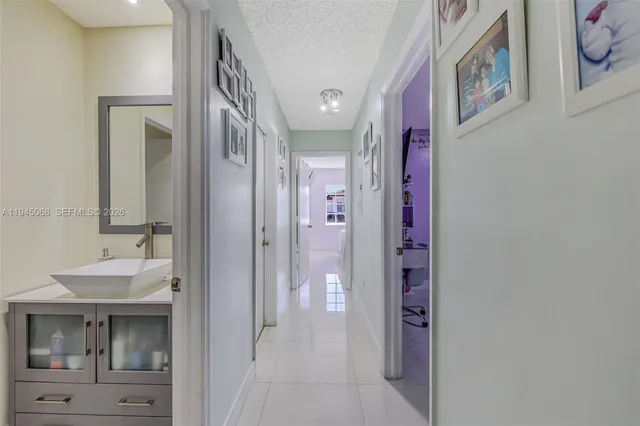a view of a hallway with wooden shelves