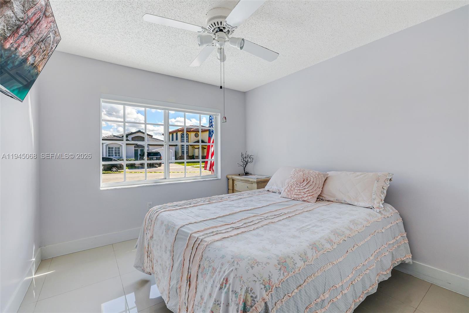 9526 Southwest 155th Avenue Miami, FL 33196 - Photo 27 of 53 a bedroom with a bed and a window