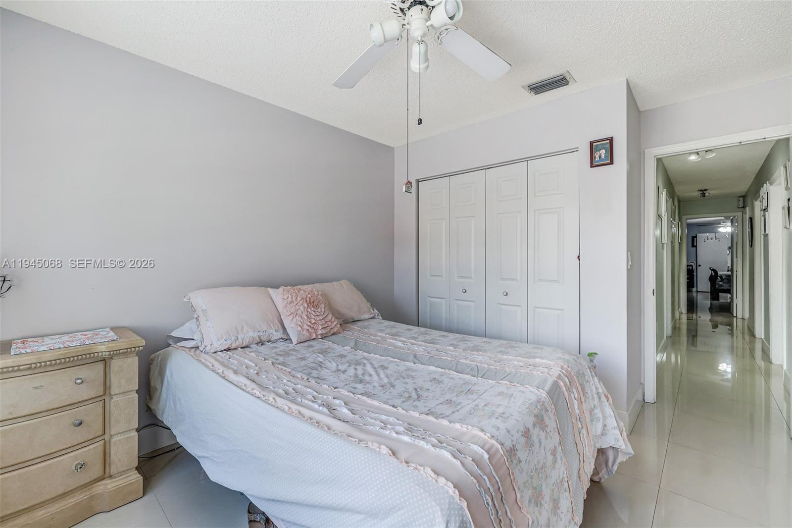 9526 Southwest 155th Avenue Miami, FL 33196 - Photo 28 of 53 a bedroom with a bed and a chandelier