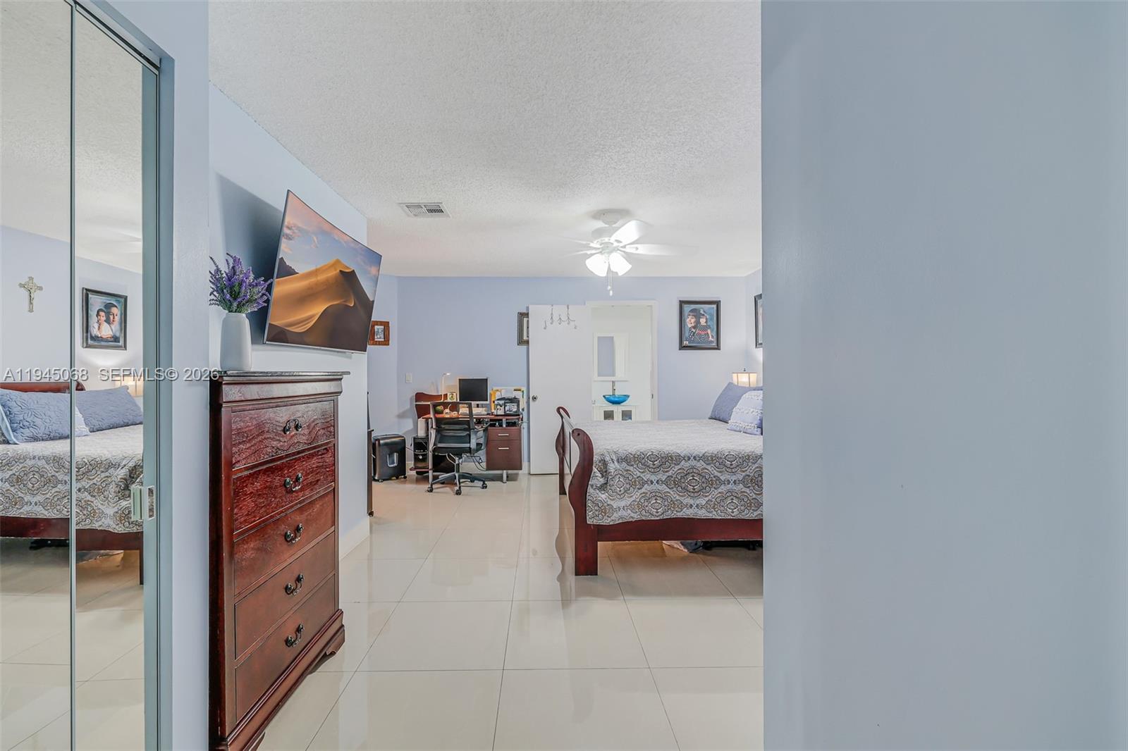 9526 Southwest 155th Avenue Miami, FL 33196 - Photo 32 of 53 a bedroom with furniture and a fireplace