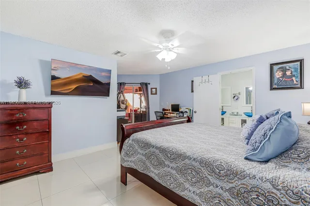 a bedroom with a bed and a painting on the wall