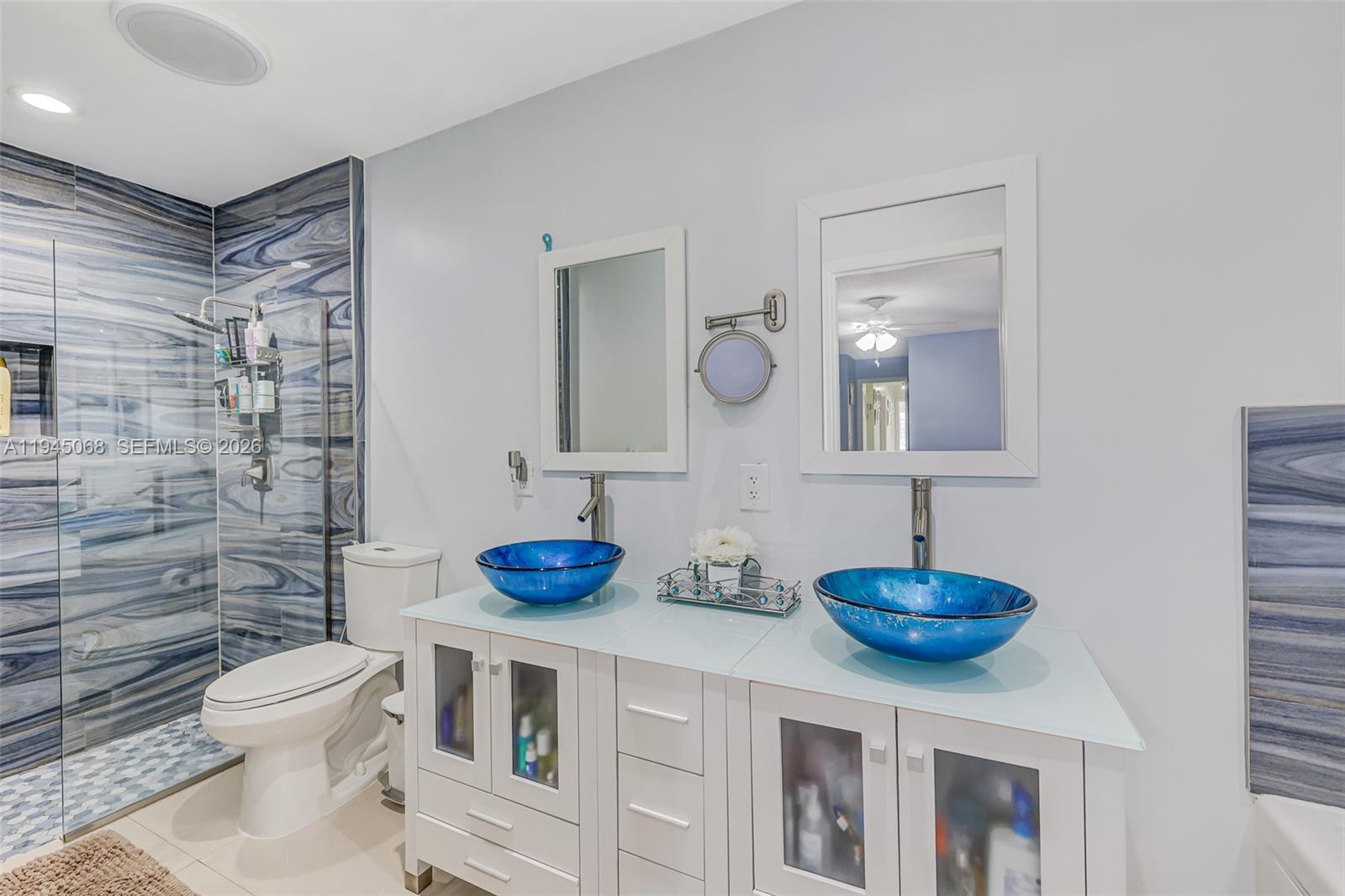 9526 Southwest 155th Avenue Miami, FL 33196 - Photo 36 of 53 a bathroom with a sink a toilet and a mirror