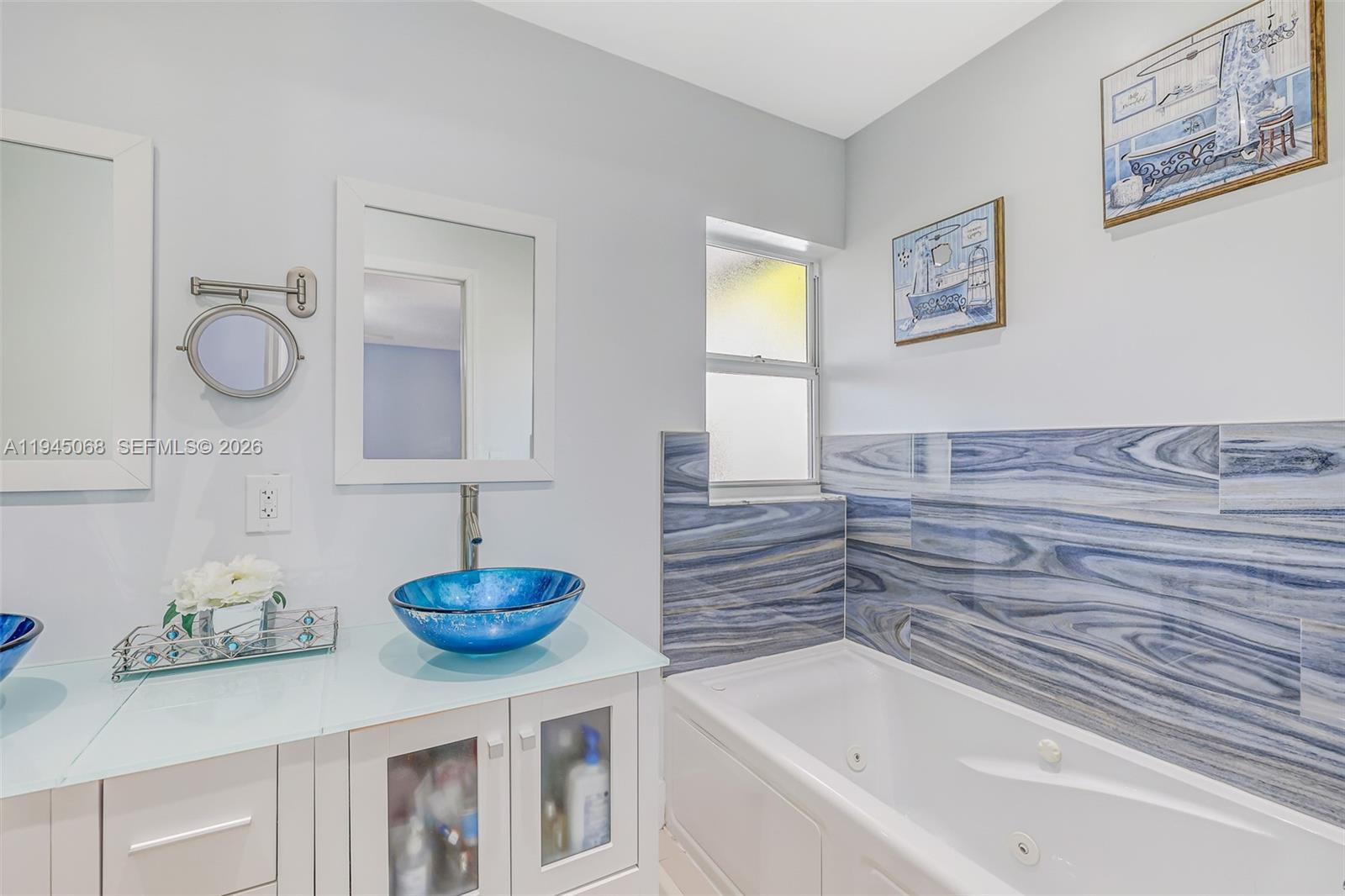 9526 Southwest 155th Avenue Miami, FL 33196 - Photo 37 of 53 a bathroom with a tub sink and a mirror