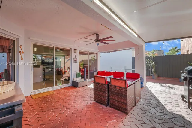 a view of a patio with a table and chairs