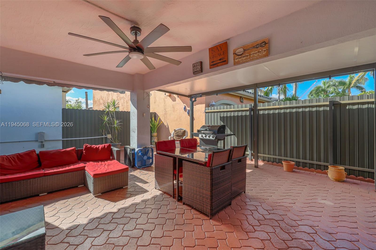 9526 Southwest 155th Avenue Miami, FL 33196 - Photo 41 of 53 a view of a patio with a table and chairs