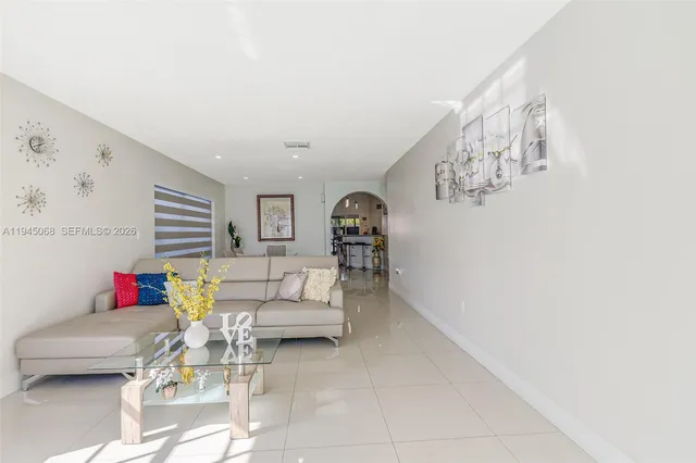 a living room with furniture and stairs