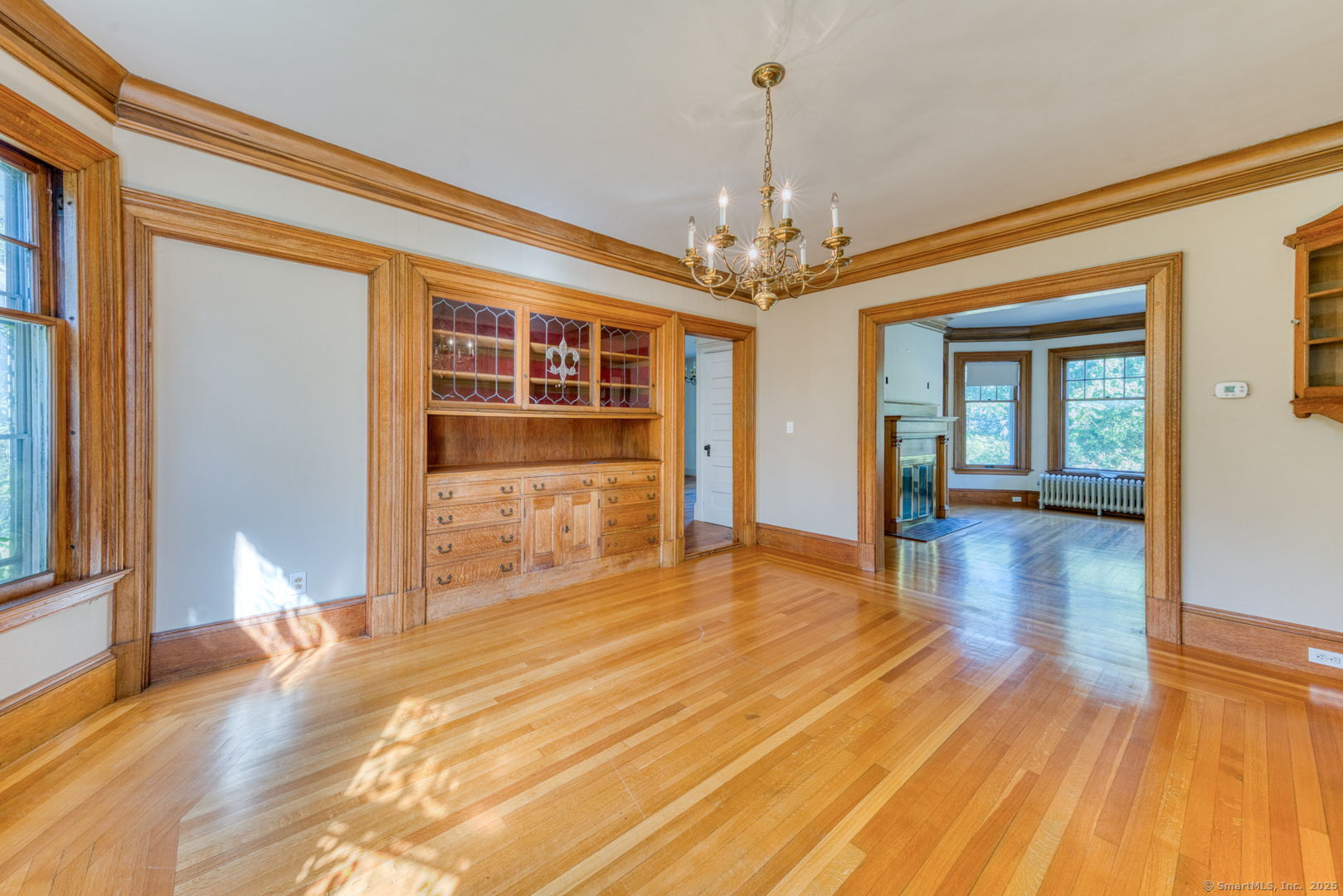 202 South Main Street Manchester, CT 06040 - Photo 11 of 40 a view of a livingroom with wooden floor and a kitchen space