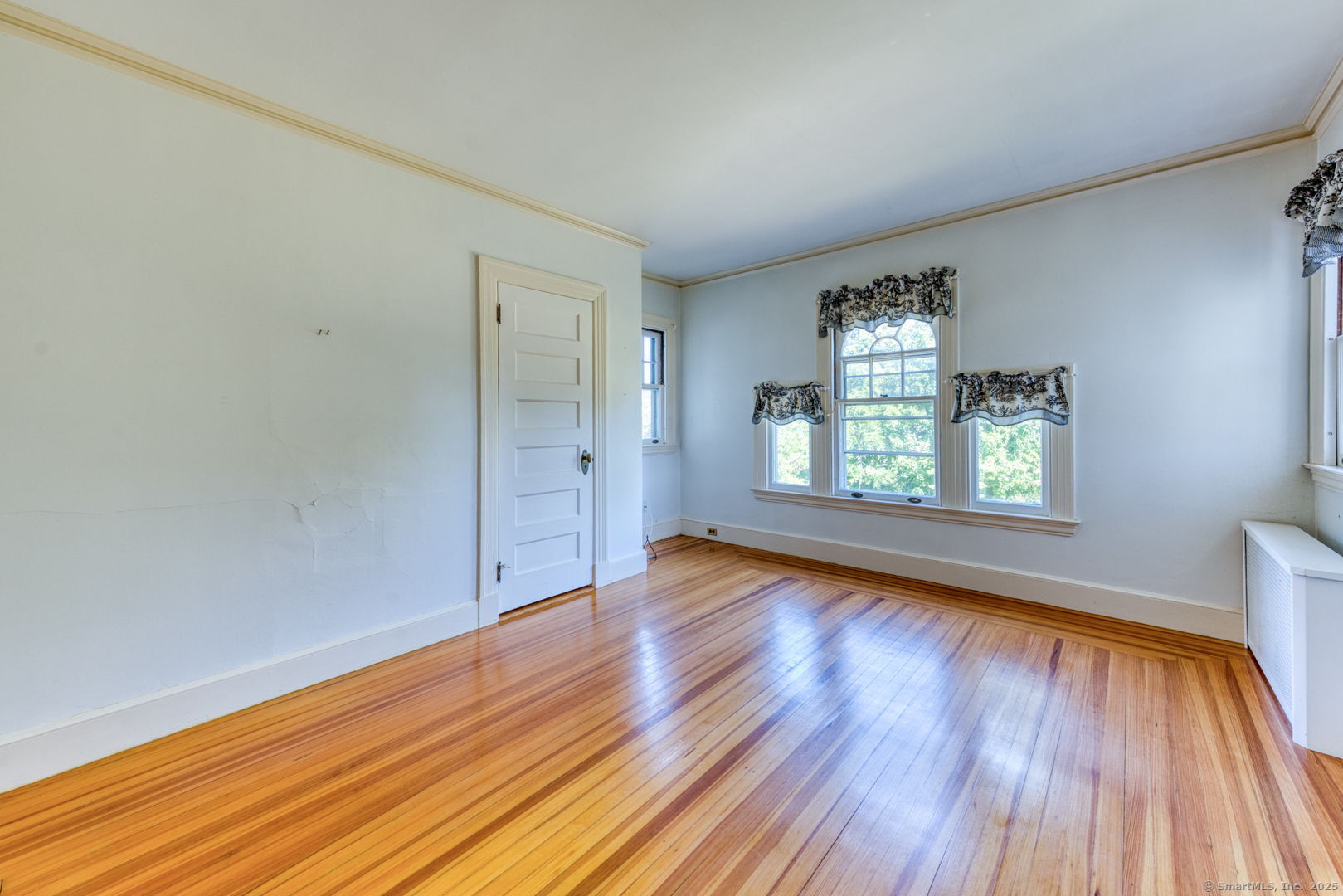 202 South Main Street Manchester, CT 06040 - Photo 19 of 40 an empty room with wooden floor and windows