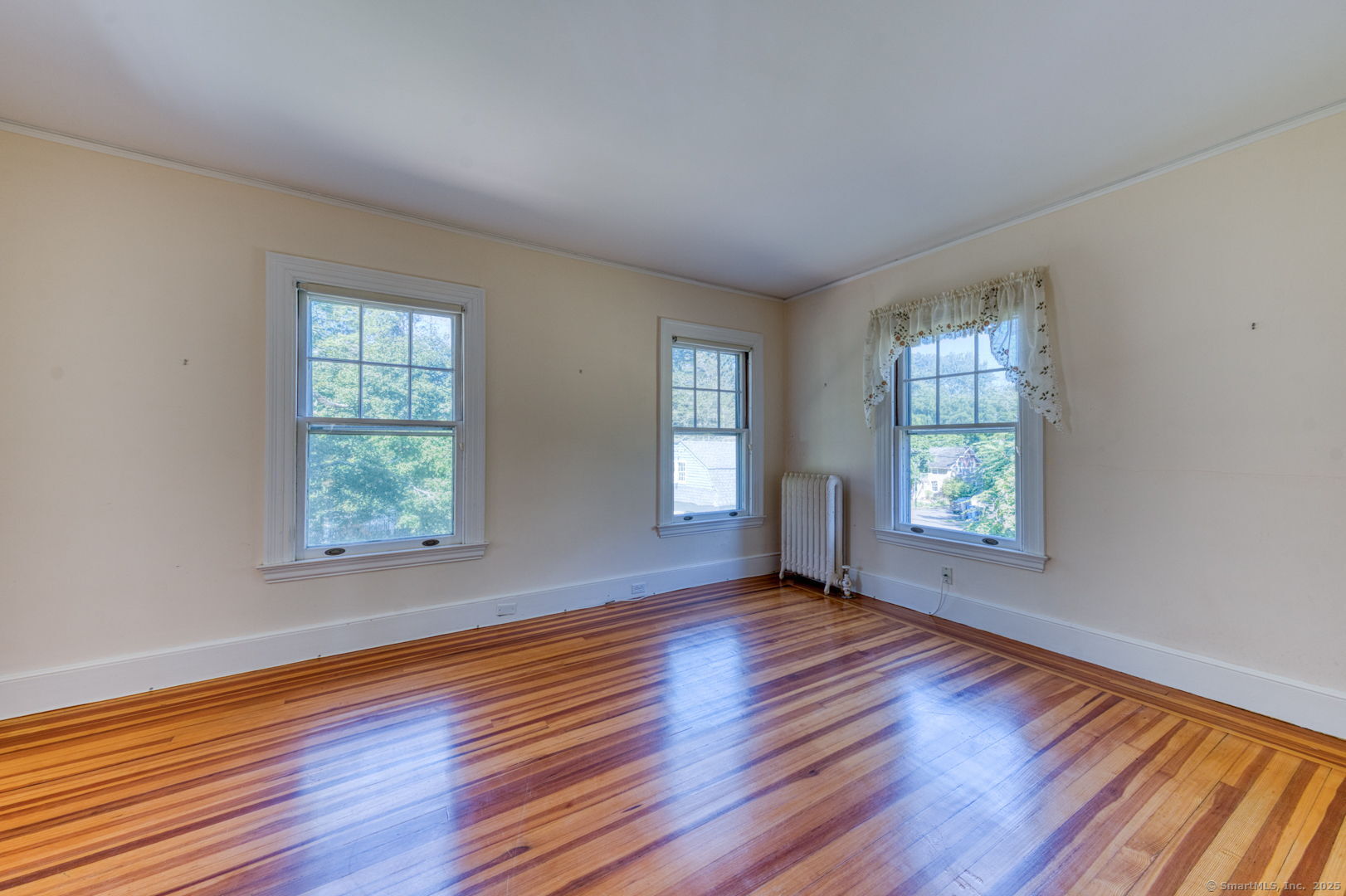 202 South Main Street Manchester, CT 06040 - Photo 23 of 40 an empty room with wooden floor and windows