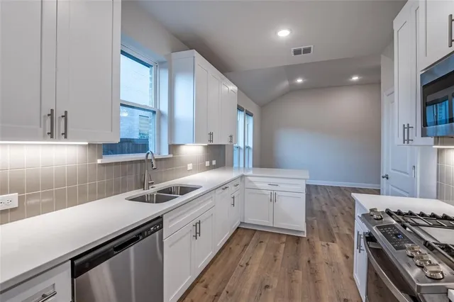 a kitchen that has a sink and a stove
