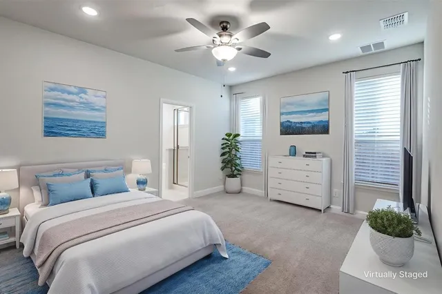 a bedroom with a bed dresser and bed