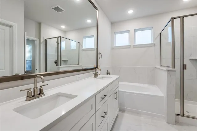 a bathroom with a tub sink and mirror
