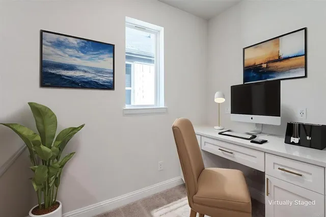 a work place with furniture and a potted plant