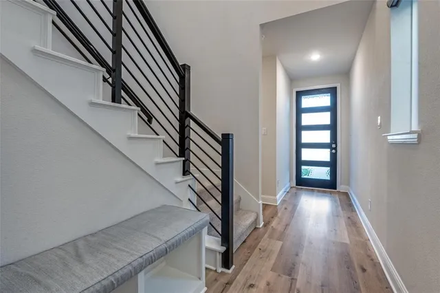 a view of entryway and hall with wooden floor