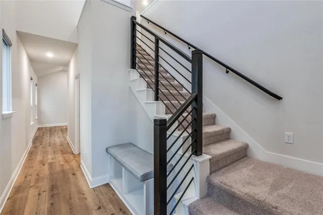 a view of entryway and hall with wooden floor
