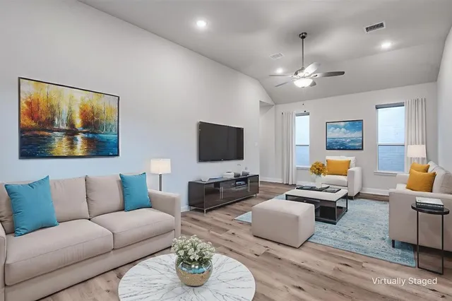 a living room with furniture and a flat screen tv