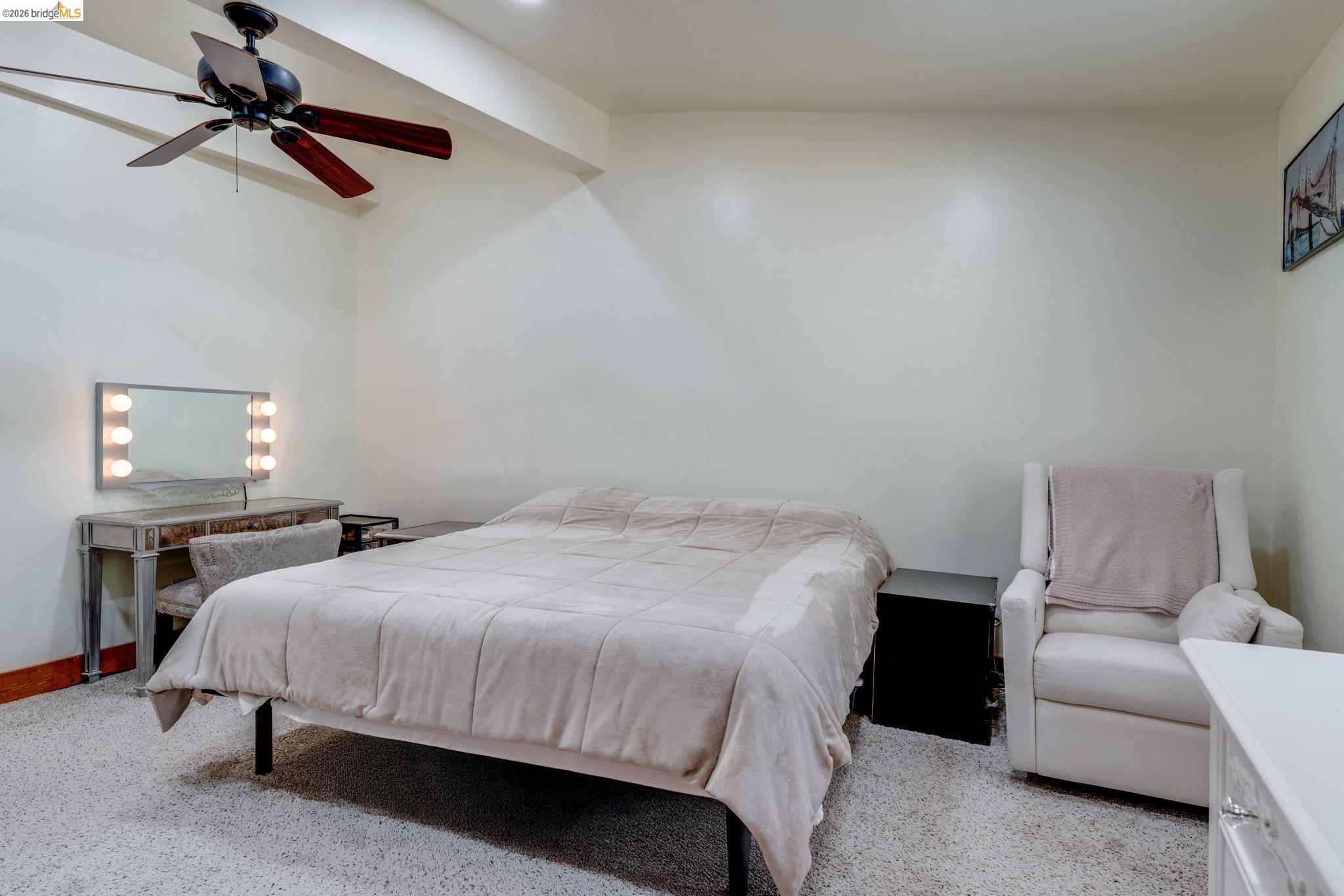 4600 El Caminito Road Shingle Springs, CA 95682 - Photo 12 of 60 a bedroom with a bed and a chandelier