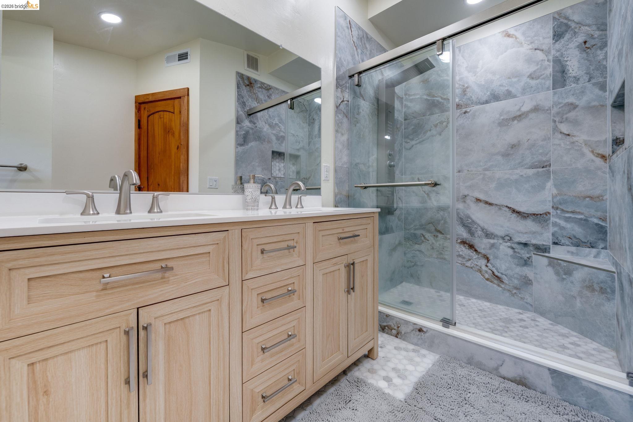 4600 El Caminito Road Shingle Springs, CA 95682 - Photo 15 of 60 a bathroom with a double vanity sink mirror and shower