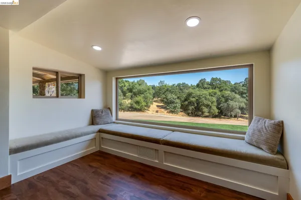 a view of backyard with large trees and outdoor seating