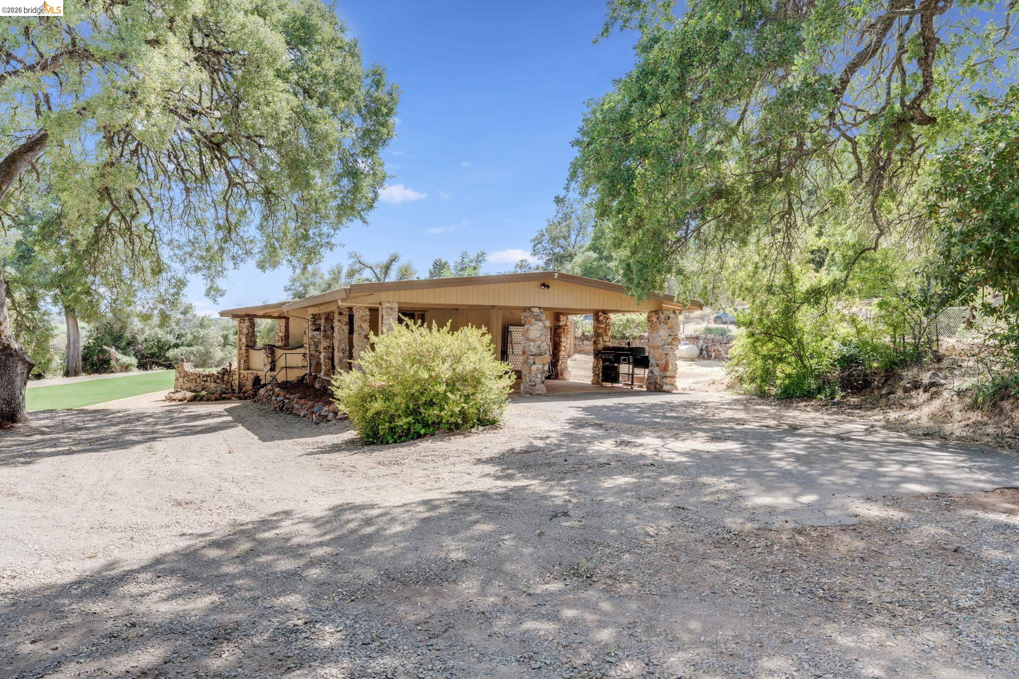 4600 El Caminito Road Shingle Springs, CA 95682 - Photo 30 of 60 a front view of a house with a yard and potted plants