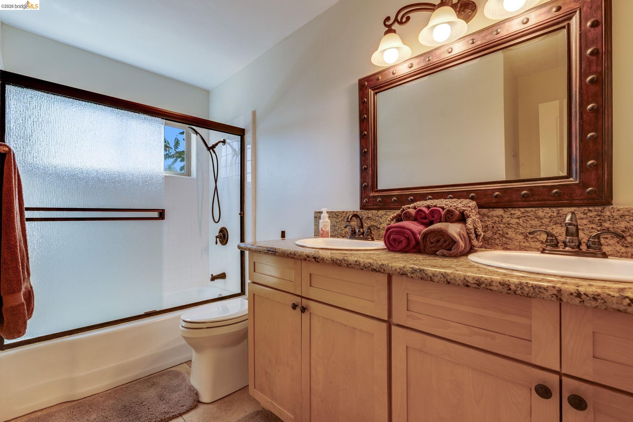 4600 El Caminito Road Shingle Springs, CA 95682 - Photo 45 of 60 a bathroom with a granite countertop sink mirror vanity and toilet