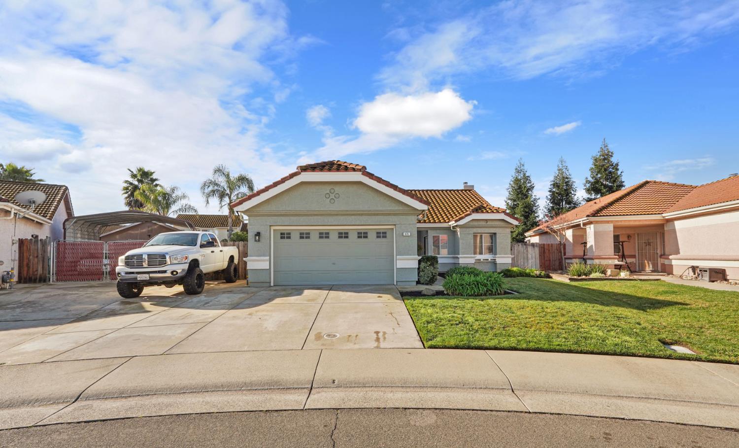 876 Cobden Way Galt, CA 95632 - Photo 1 of 1 a front view of a house with a garden and plants