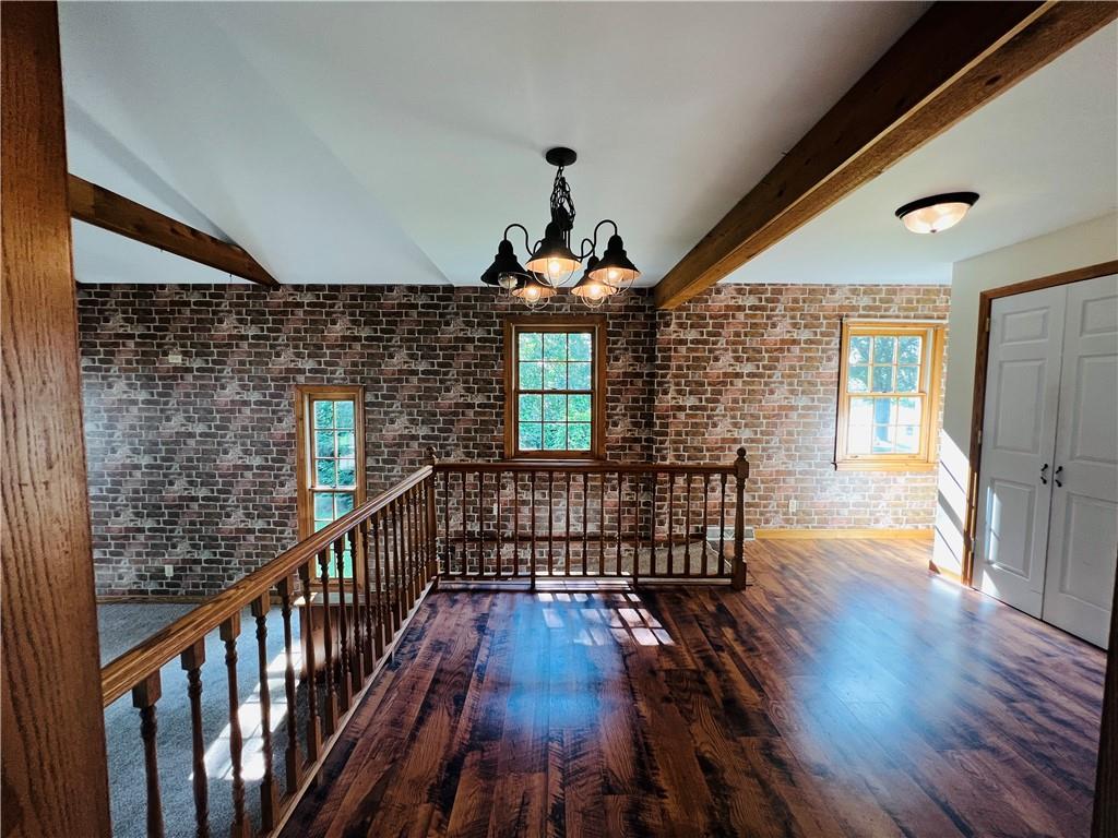 2764 Old Butler Road New Castle, PA 16101 - Photo 12 of 25 a hallway with wooden floor windows and a chandelier