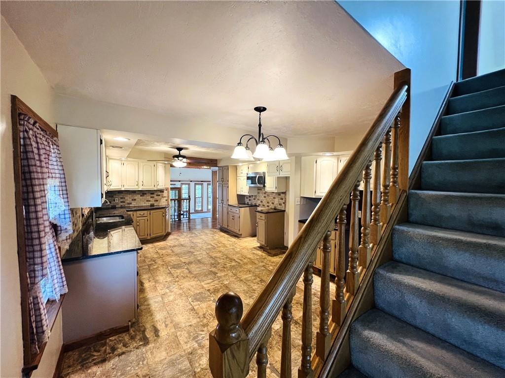 2764 Old Butler Road New Castle, PA 16101 - Photo 17 of 25 a view of a livingroom with furniture staircase and kitchen view