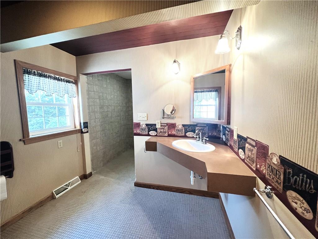 2764 Old Butler Road New Castle, PA 16101 - Photo 20 of 25 a spacious bathroom with a sink a mirror and a bathtub