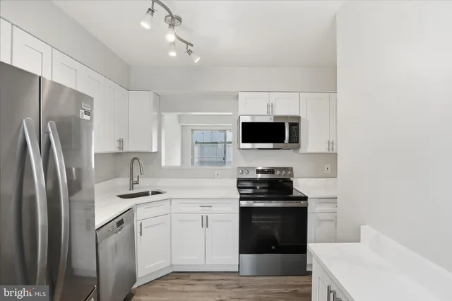 a kitchen with a sink stove and refrigerator