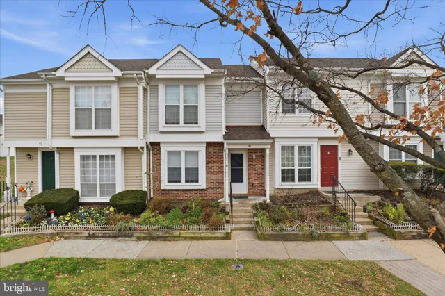 a front view of a house with porch and glass windows